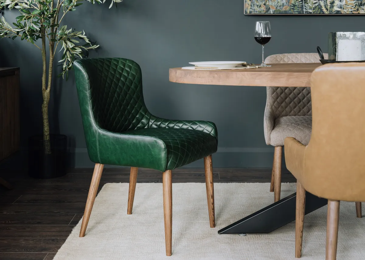 A lifestyle image of the Oslo dining chair in green with the Oslo table.
