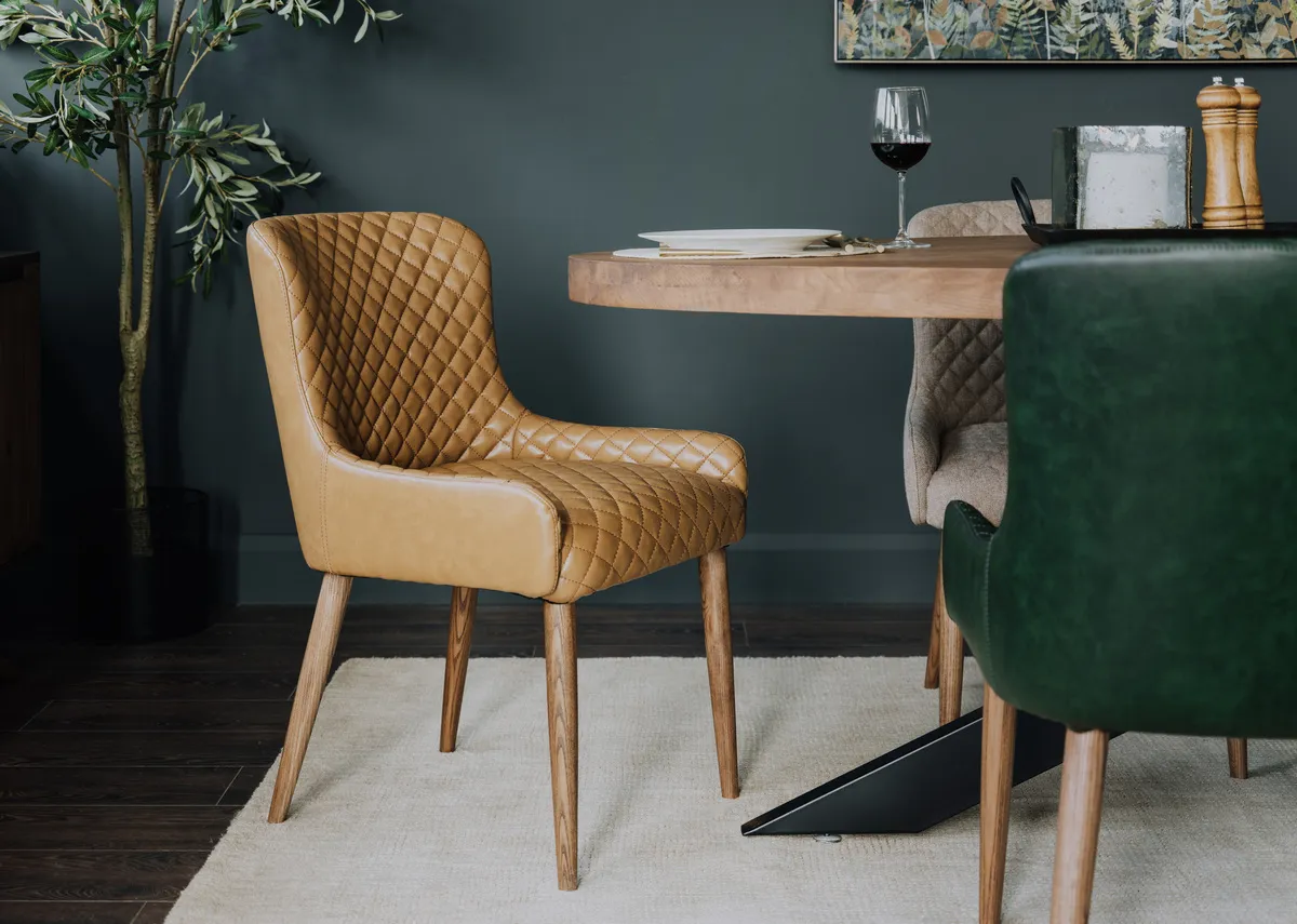 A lifetsyle image of the Oslo tan dining chair with the Oslo table