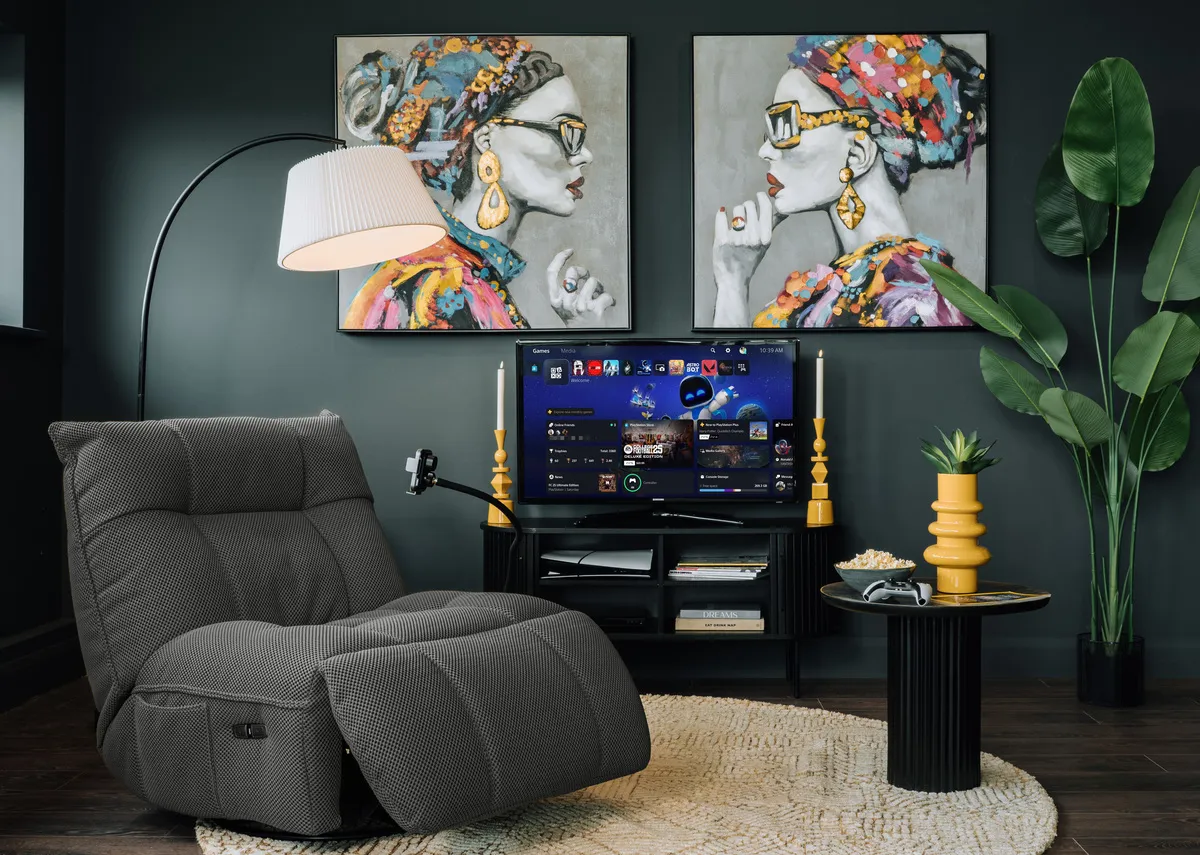 A lifestyle image of the Java glider in grey with Contessa pictrues with arc lamp.