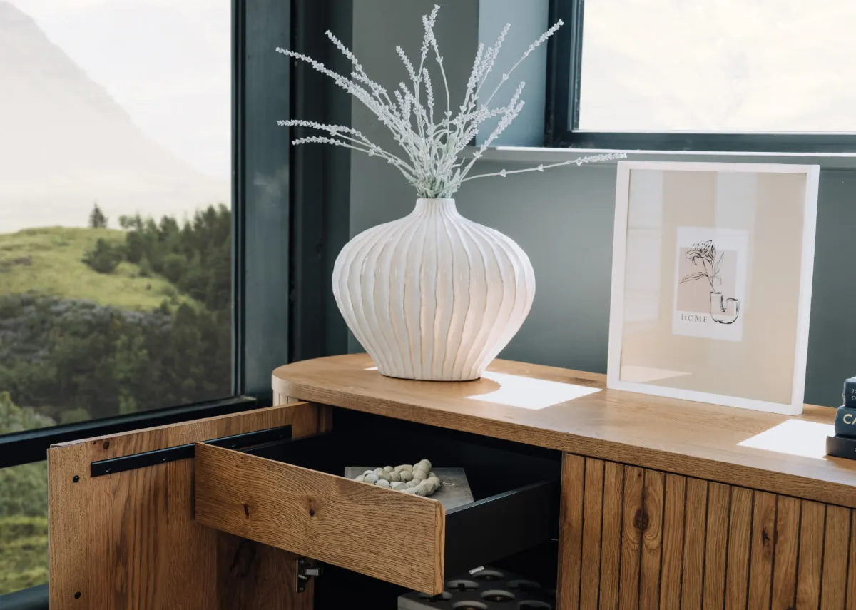 A lifestyle image of the Vega sideboard with Lorito vase and Myla frame.