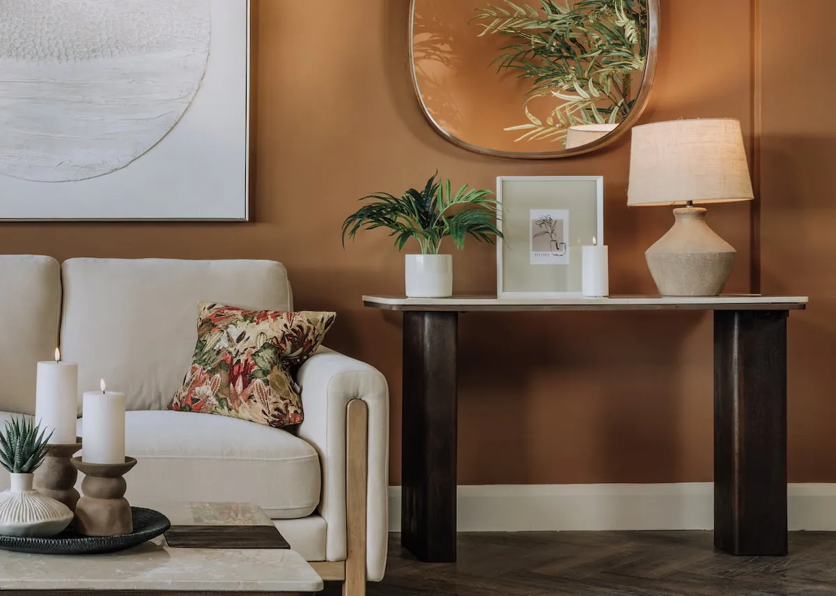 A lifestyle image of the Zia Mirror over the Windsor console with Myla frame and Mai lamp.