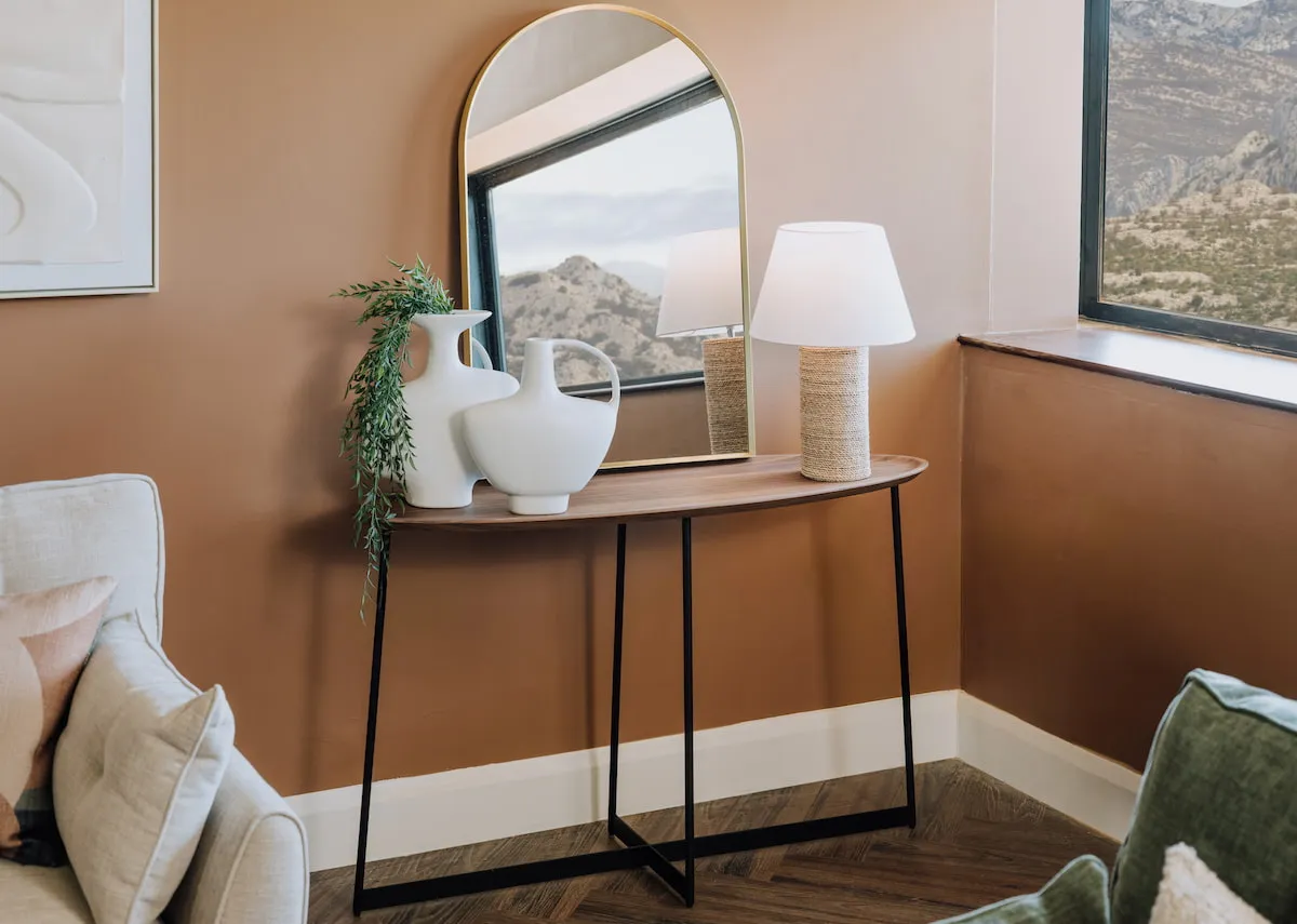 A lifestyle image of the Bonita console table with the Flynn mirror and Edith lamp.