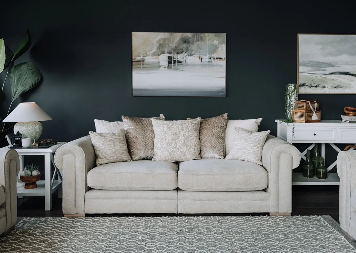 A lifestyle image of the Olivia pillowback 4 seater with the Marina mooring canvas and Newry lamp on Hampton side table.