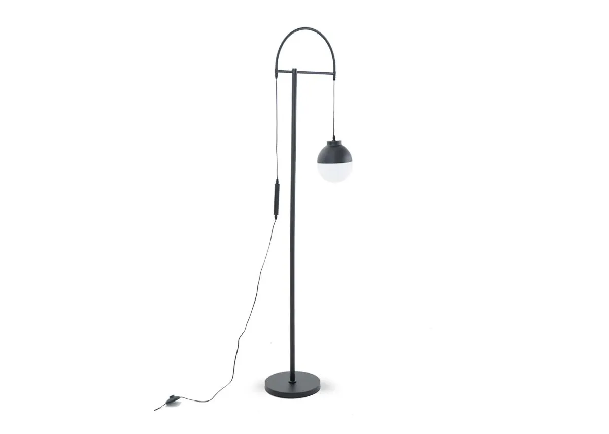 A black floor lamp from EZ Livings Casper range. Angled view of black metal lam;p with white pendant bulb.