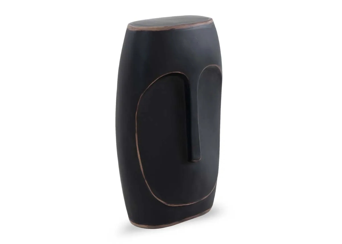A large black vase with distressed edges from EZ Livings Bluebell range. Angled view of face like design