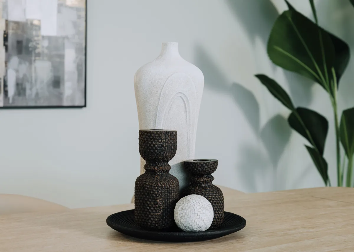 A lifestyle image of the jade ornament ball with other items from the Resin range displayed on a table