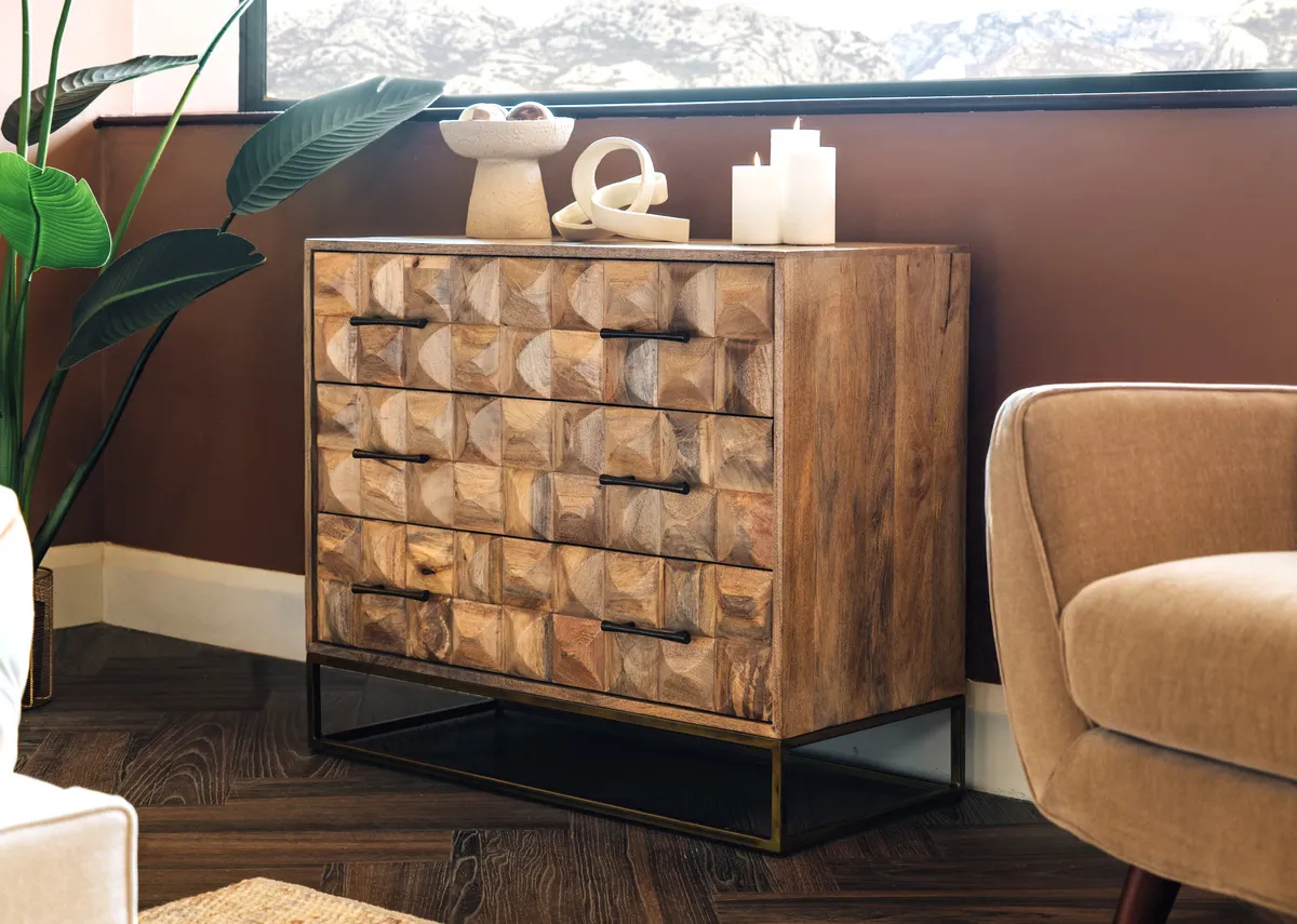 A lifestyle image of the Diva chest with a selection of ornaments and candles.