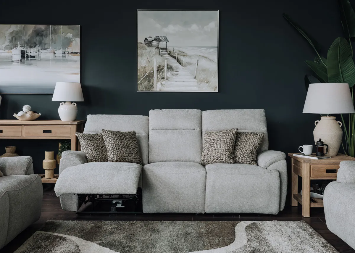 A lifetsyle image of the Mallow silver 3 seater with Journey canvas and Oak side and console table