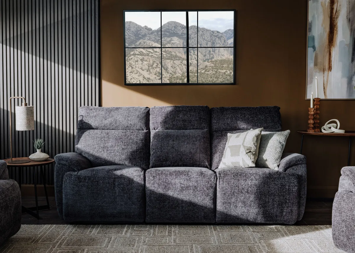A lifestyle image of the Mallow charcoal 3  seater in fixed mode with Inspired  canvas and Memphis rug.