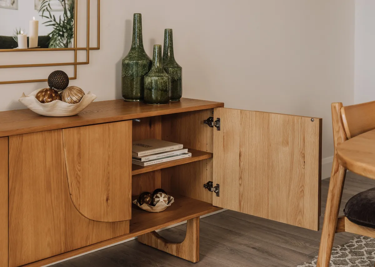 A lifestyle image of the Pierro sideboard with door open to show interior storage.