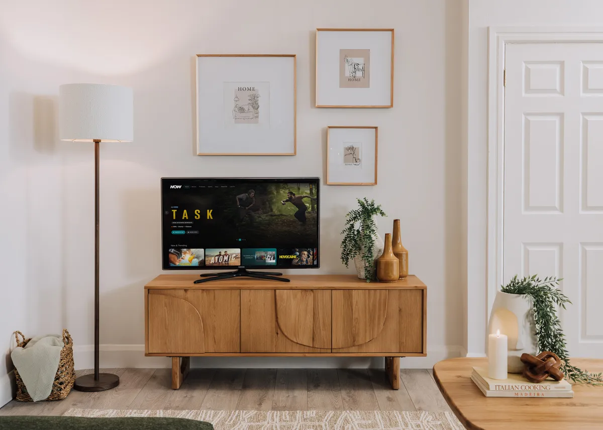 A lifetsyle image of the Pierro tv unit with tv and Myla photo frames in gallery above.