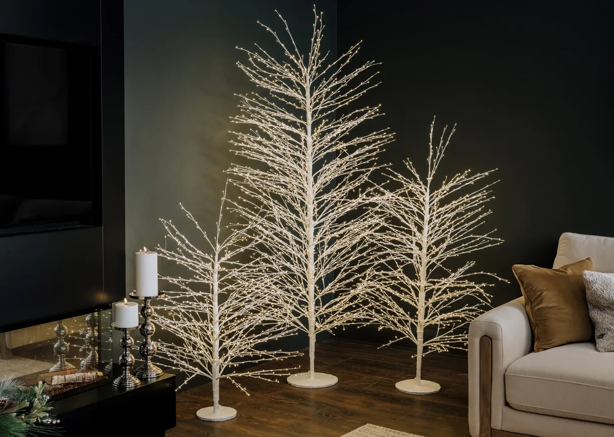 A lifestyle image of the Spirit tree in 4ft6 5ft and 6ft beside the Miller sofa.