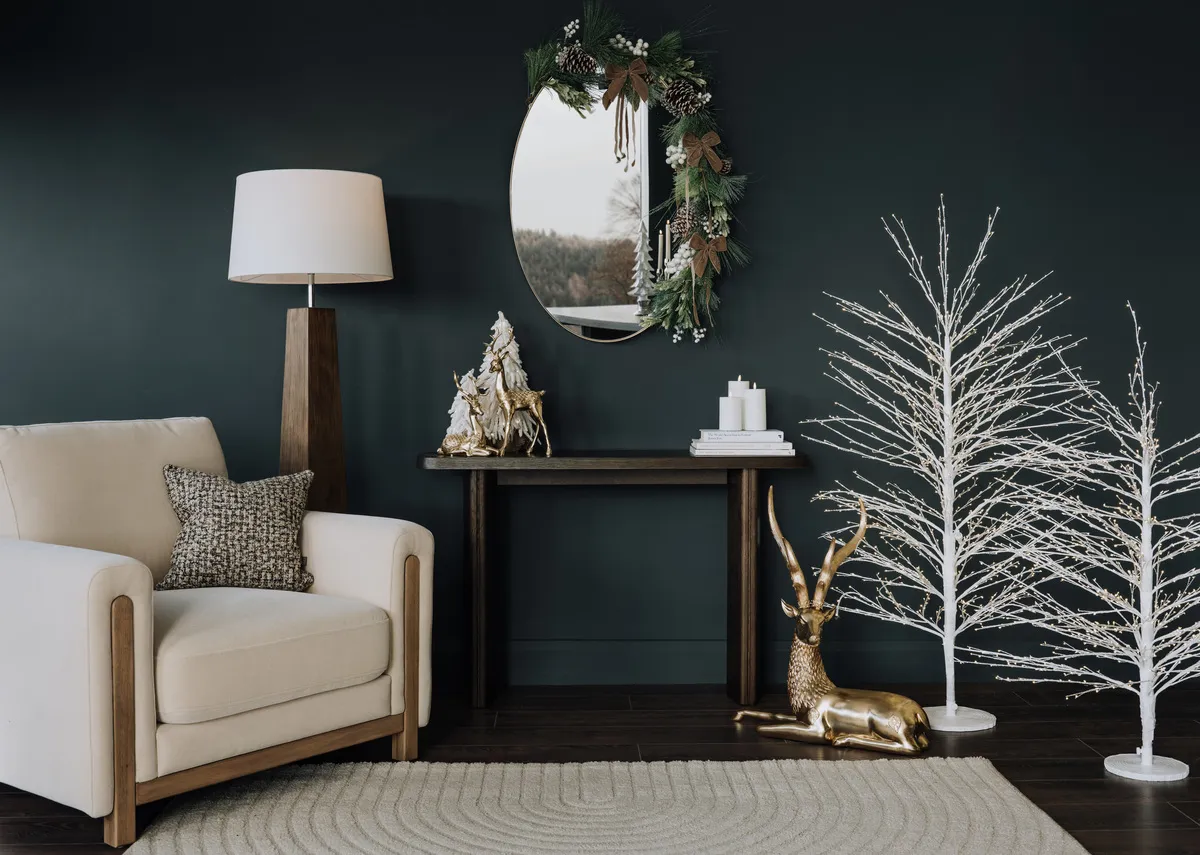 A lifestyle image of the Vita mirror and Romini consle with frosted garland and taupe bows