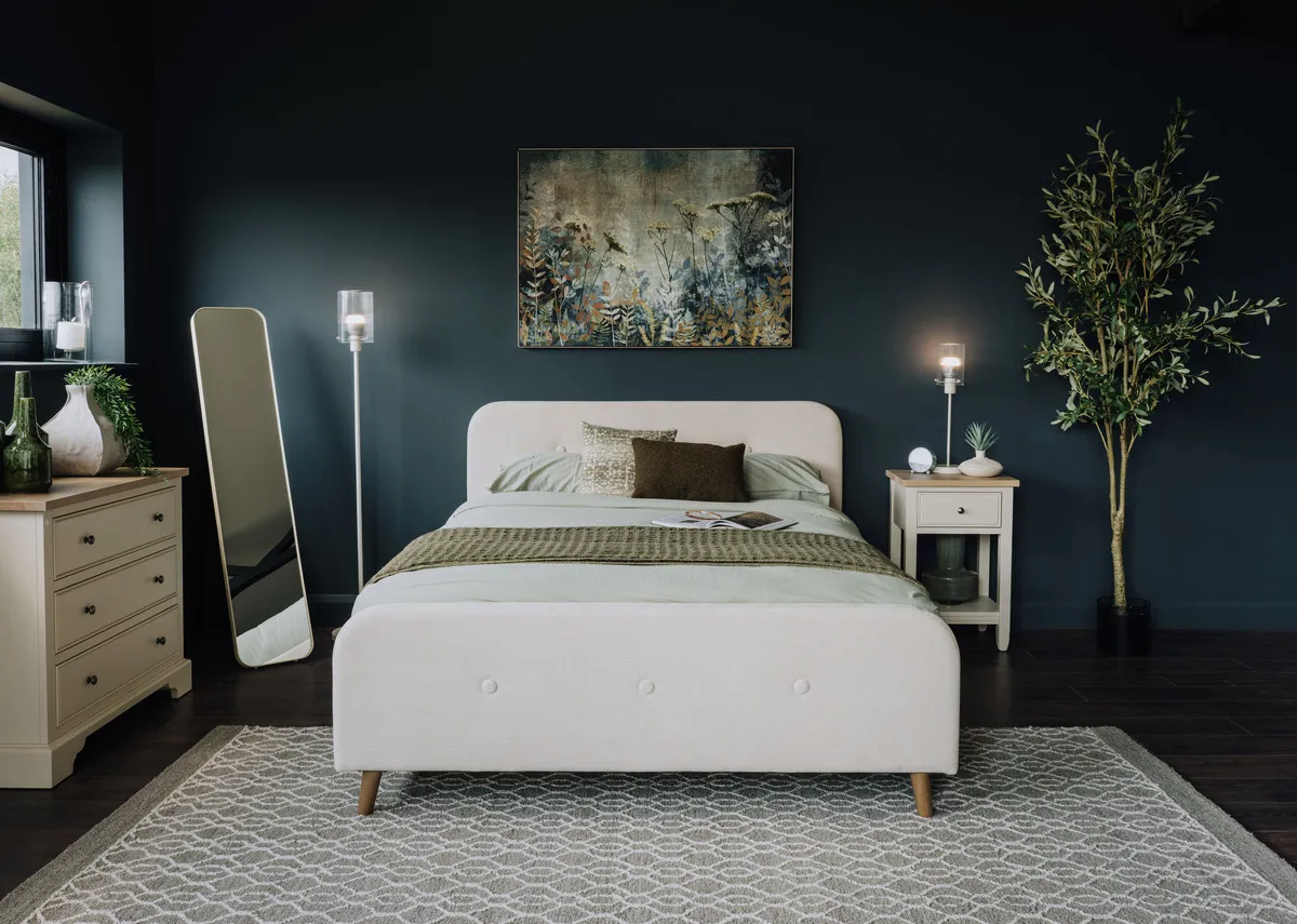 A lifestyle image of the Heiny rug with Serena bed in cream and fanciful canvas.