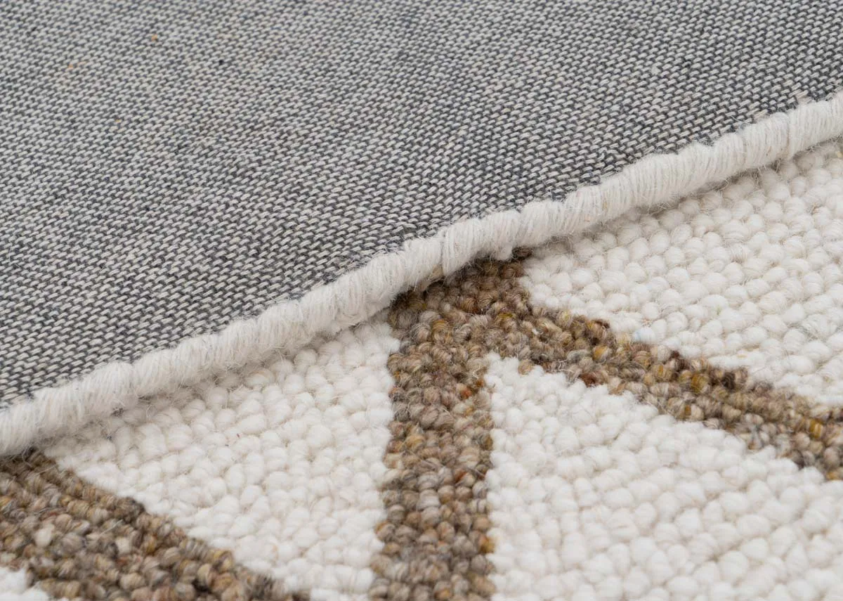 A cream rug with gold slashes from EZ Livings Monterose range.Closeup of gold fibres