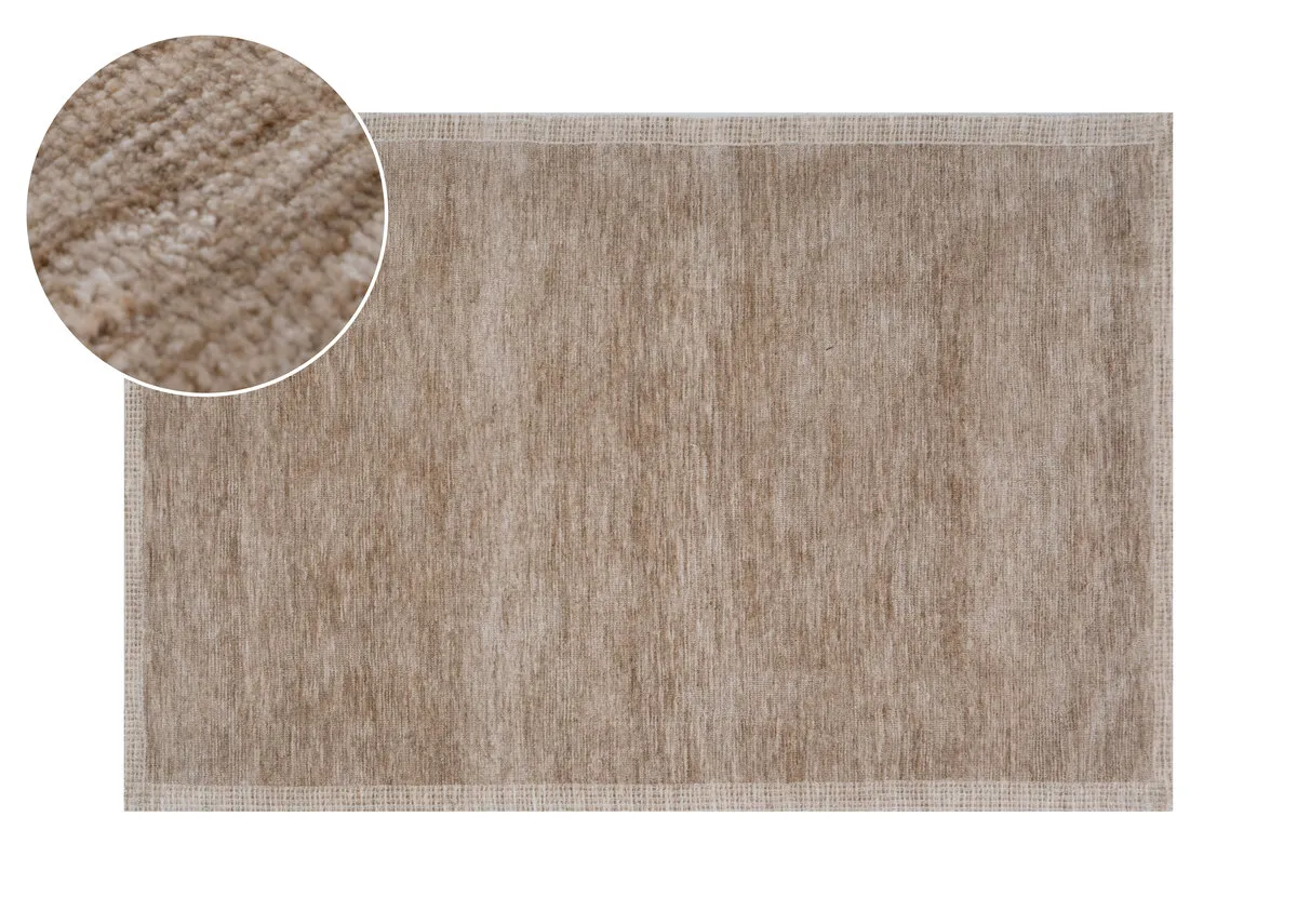 A rectangular rug in a light sandy beige colour displaying a uniform textured surface with a subtle border.