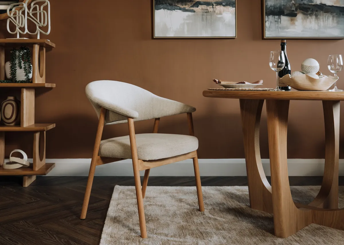 A lifestyle image of the Elk dining chair with Flow dining table and Menlo rug.