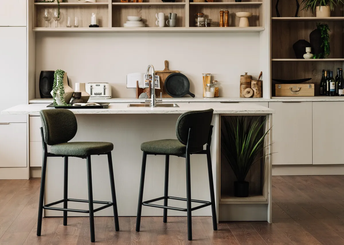 A lifestyle image of two Swan green bar stools at a kitchen island. 
