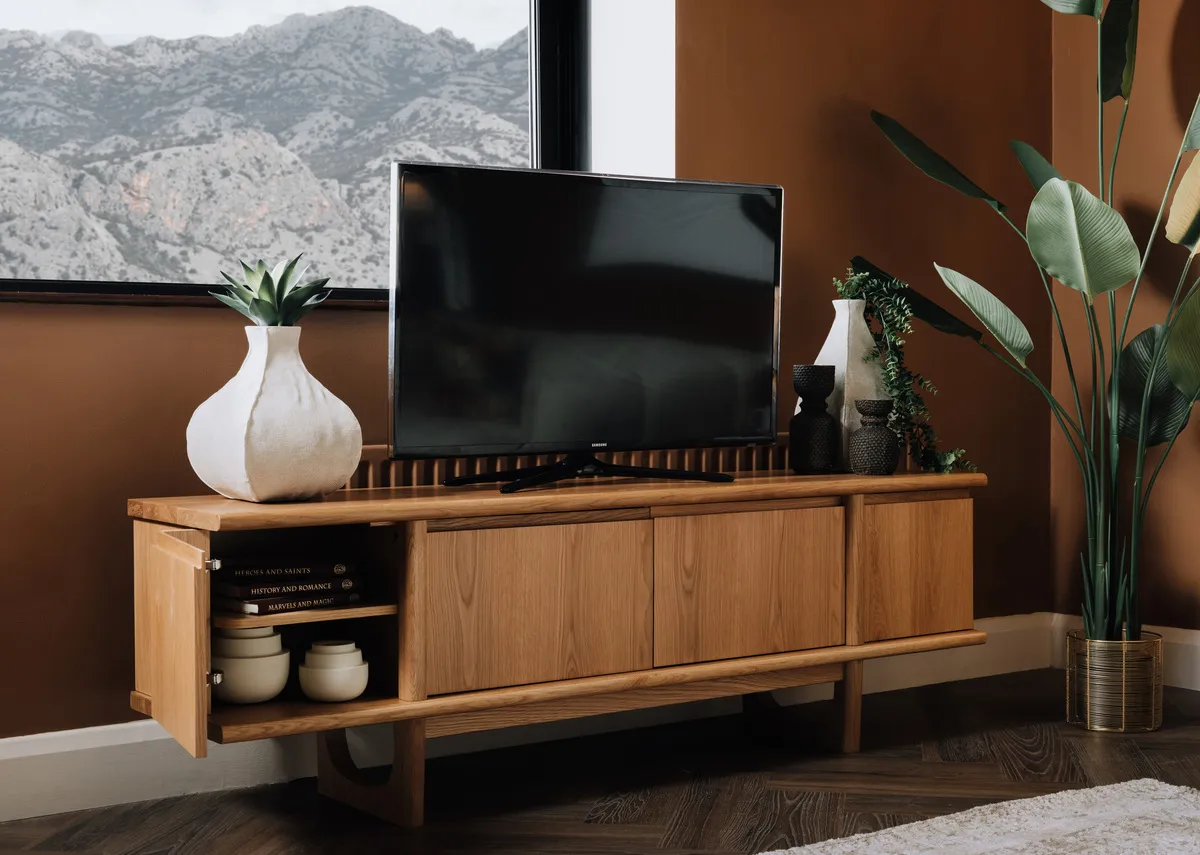 A lifestyle image of the Flow natural tv unit with door open showing storage.