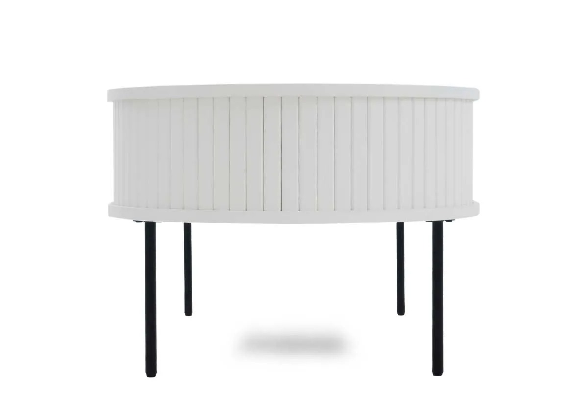 A white oval coffee table with a slatted facade and black legs shown from the front with all compartments closed.