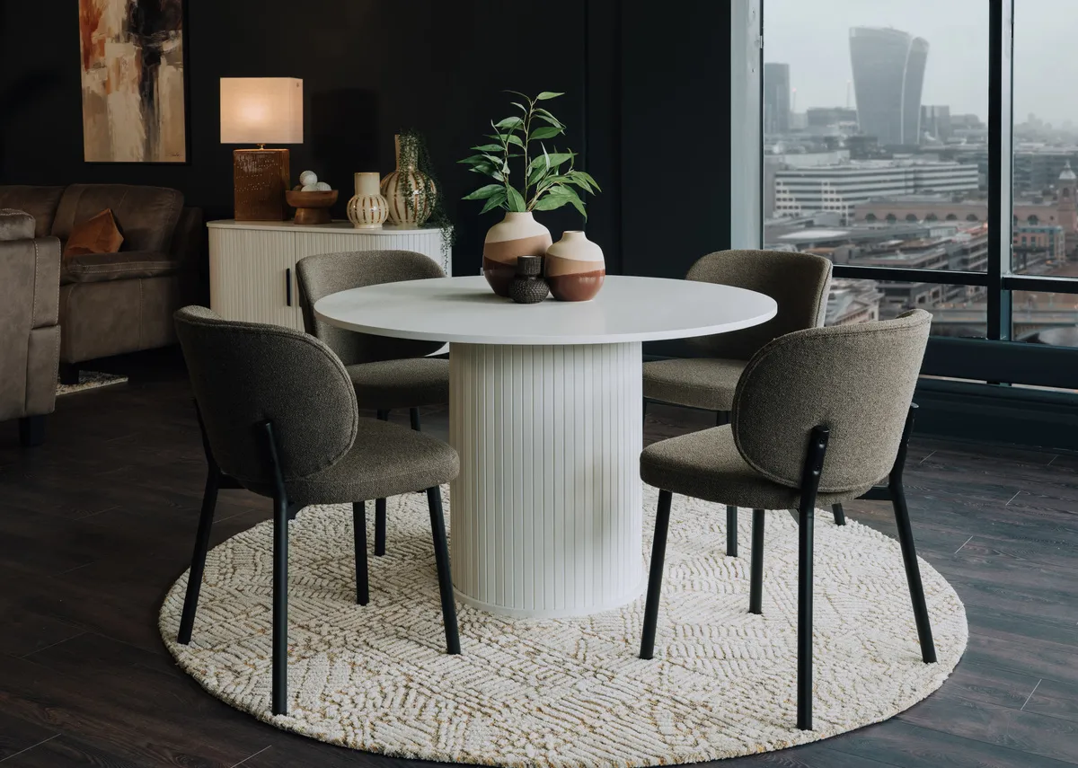 A lifetsyle image of the Nola white dining table with Wishbone dining chairs.