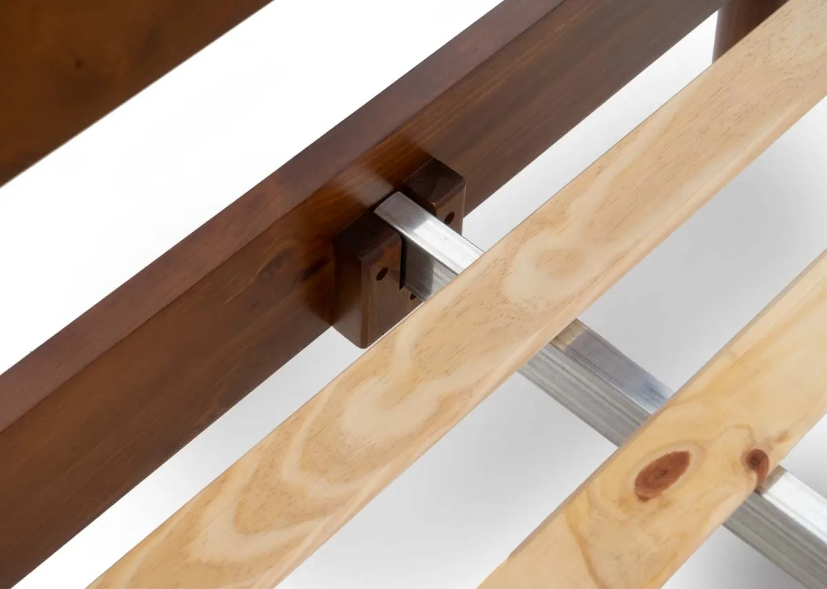 A close up of the bed frames internal structure revealing the wooden side rail a metal support beam and several wooden slats.