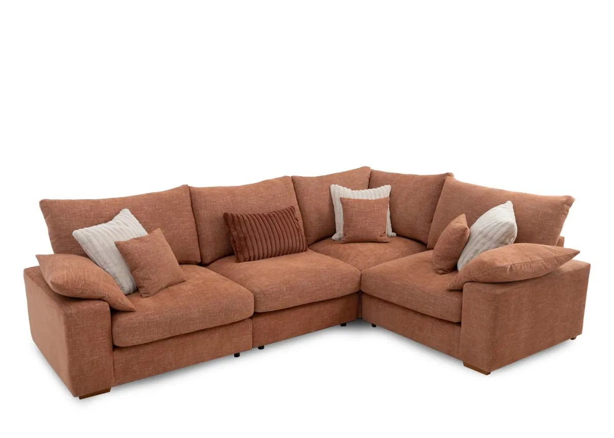 A light orange fabric corner sofa from EZ Livings Gracie range. Angled view of sofa with 7 scatter cushions.