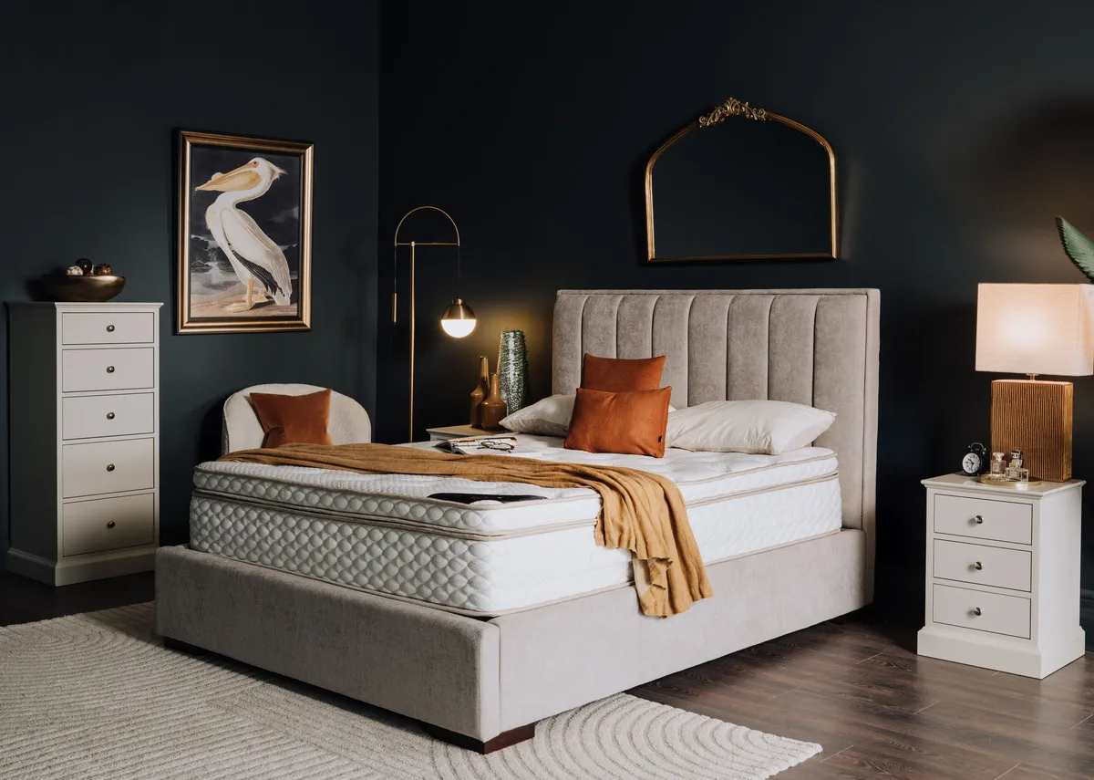 A lifestyle image of the Natural cashmere on the Liberty bed with rivendale chests.