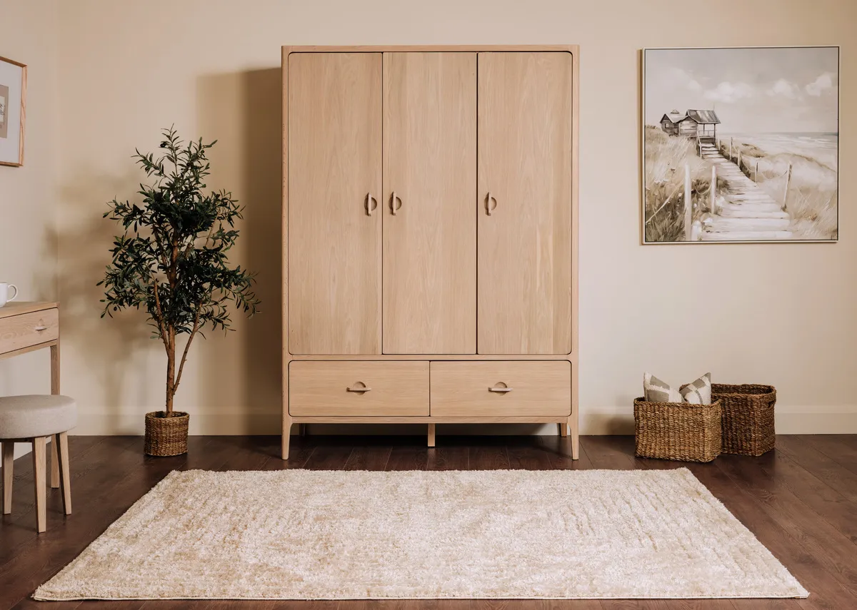 A lifestyle image of the Cadence rug with the Jay wardrobe and Jouney canvas.