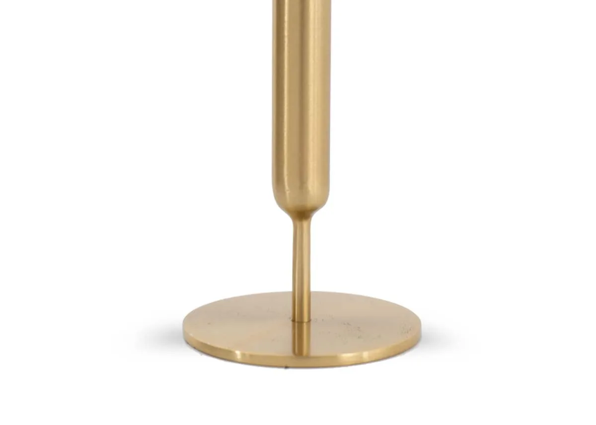 A gold metal candle stock holder with a closeup on the disc shaped base.