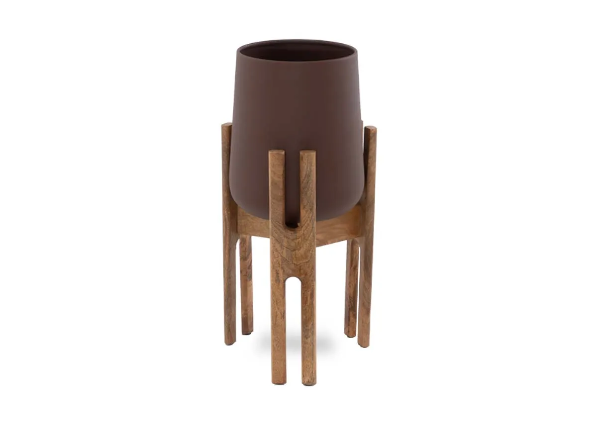 A brown planter from EZ Livings Tearose range. Front view of plant pot in a natural wood elevated holder.