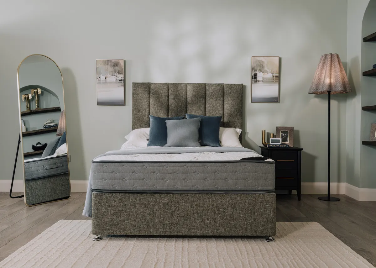 A lifestyle image of a Divan bed with Executive opulence mattress with Washington lamp and vance mirror.