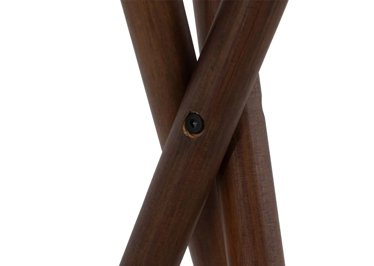 A wooden tripod floor lamp with white barrel shade.Closeup of wooden base
