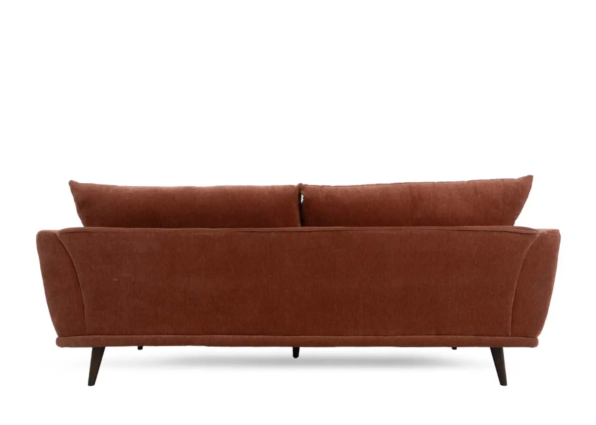Four seater sofa in rust colored fabric showing the back and two back cushions.