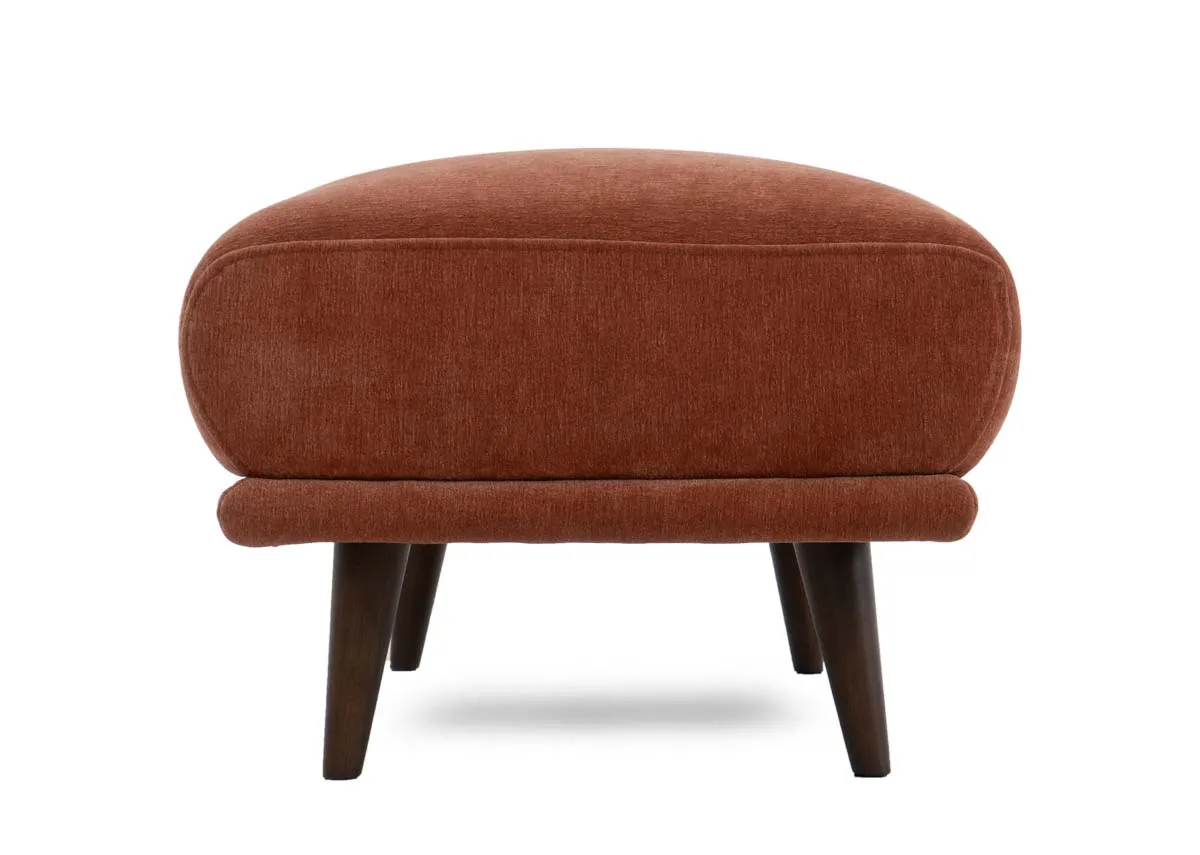 Closeup view of the rounded corner and fabric texture of the Boutique footstool.