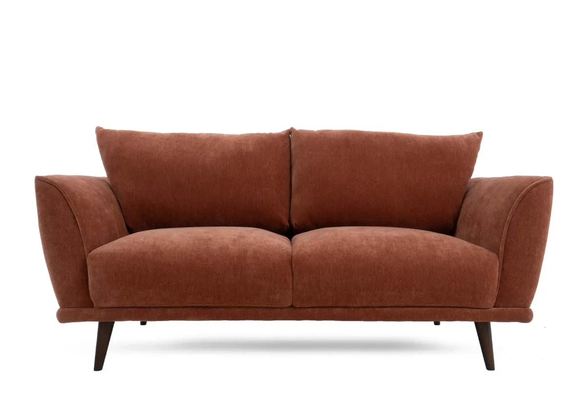 Two seater sofa in rust colored fabric presented from a straight on front view with two seat and two back cushions.