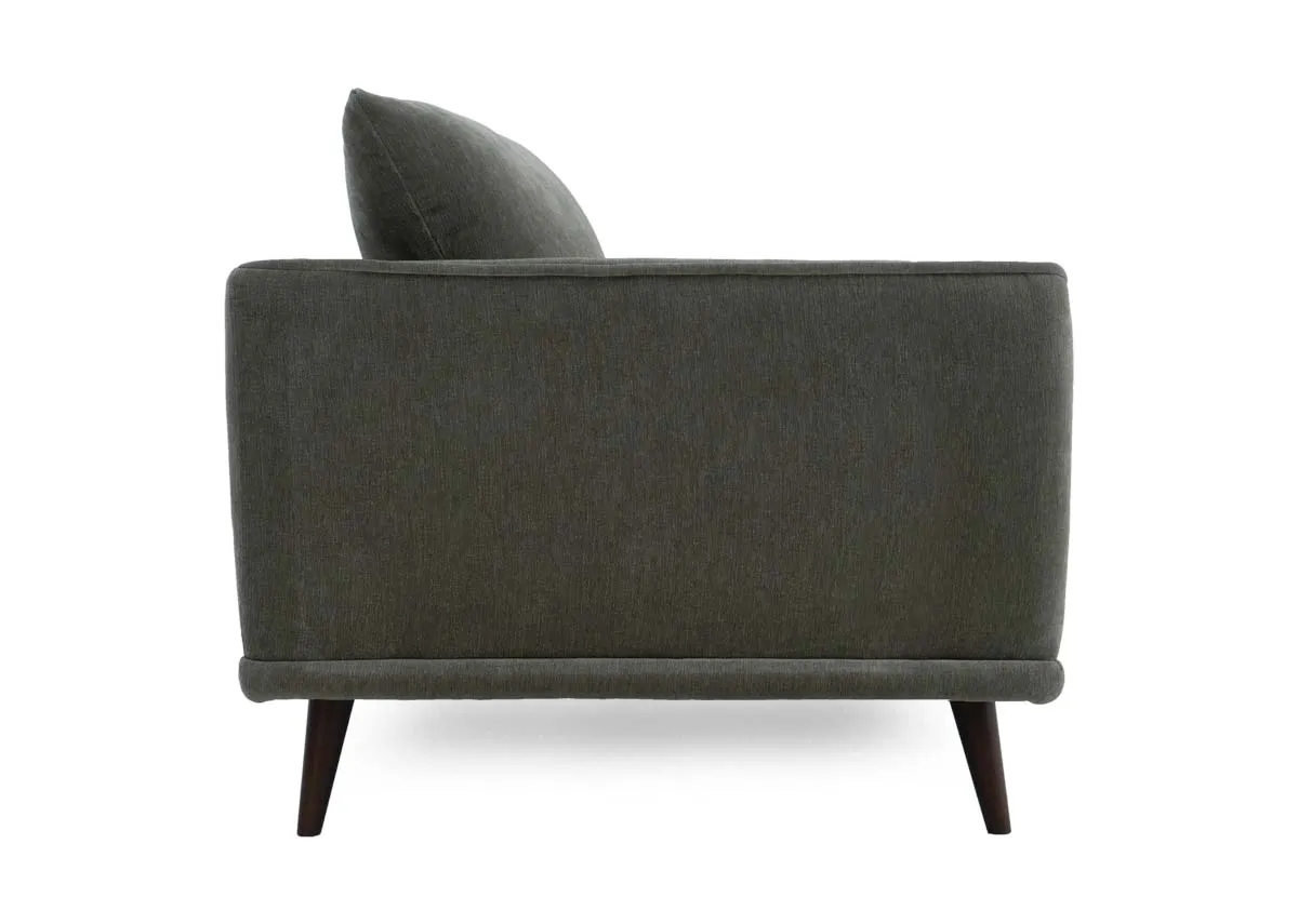 Two seater sofa in olive green fabric showing the side profile with the armrest and flared back cushion.