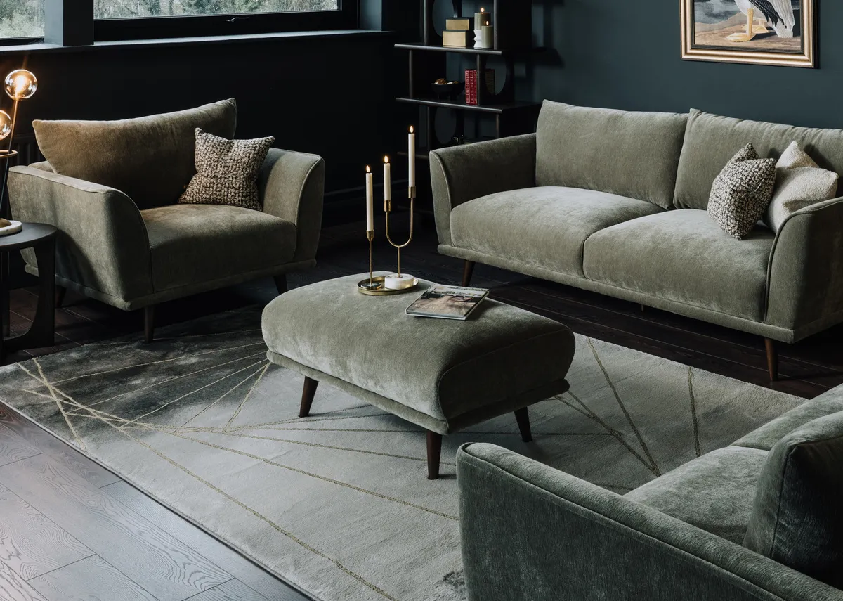A lifestyle image of the Boutique cuddler and footstool with avery rug.