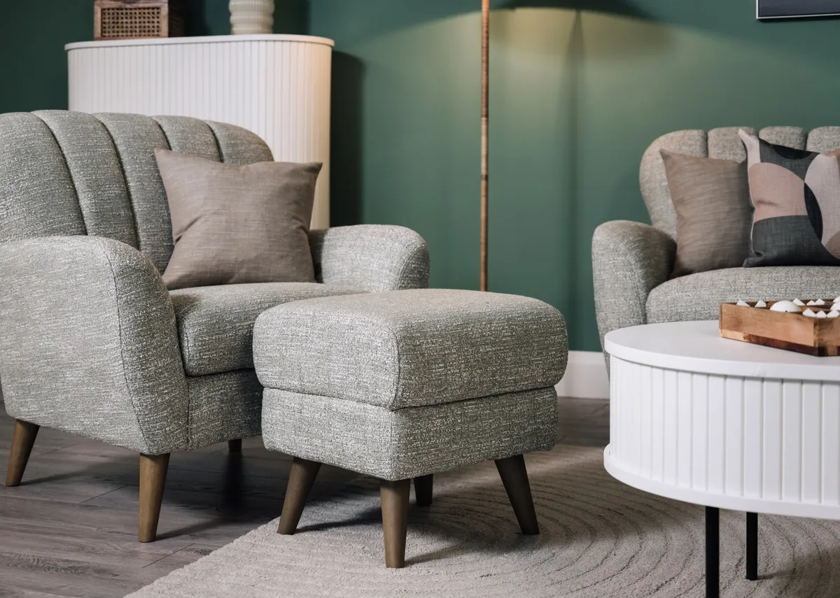 A lifestyle image of the Harper footstool with matching armchair and Nola white coffe  table.