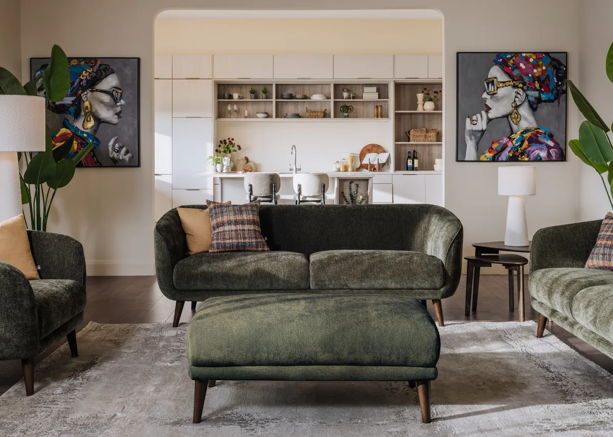 A lifestyle image of the Amebr green sofa set with footstool and Contessa canvas pictures.