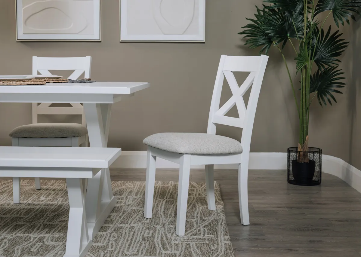 A hampton white dining chair with dining table with Raleigh rug.