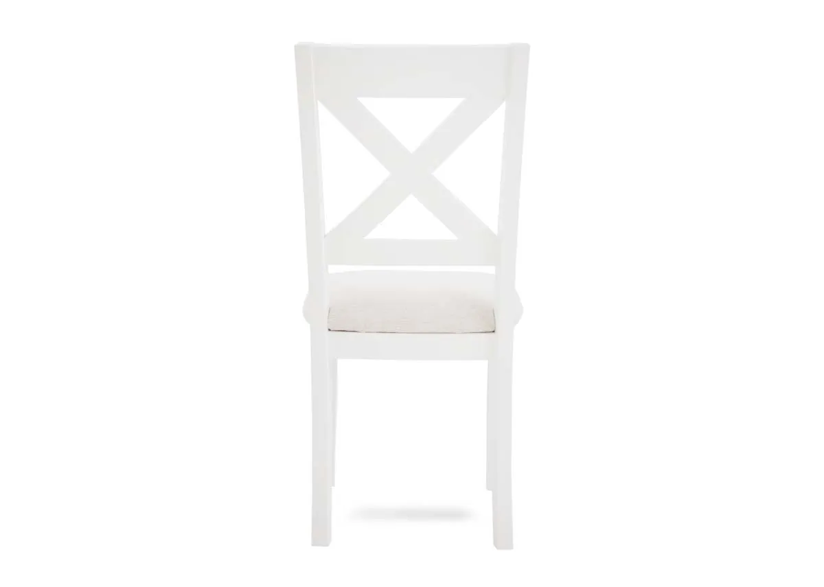 A white x back dining chair from EZ Livings Hampton range. Back view