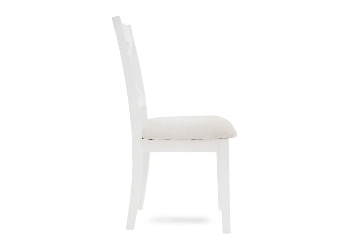 A white x back dining chair from EZ Livings Hampton range. Side view of painted finish.