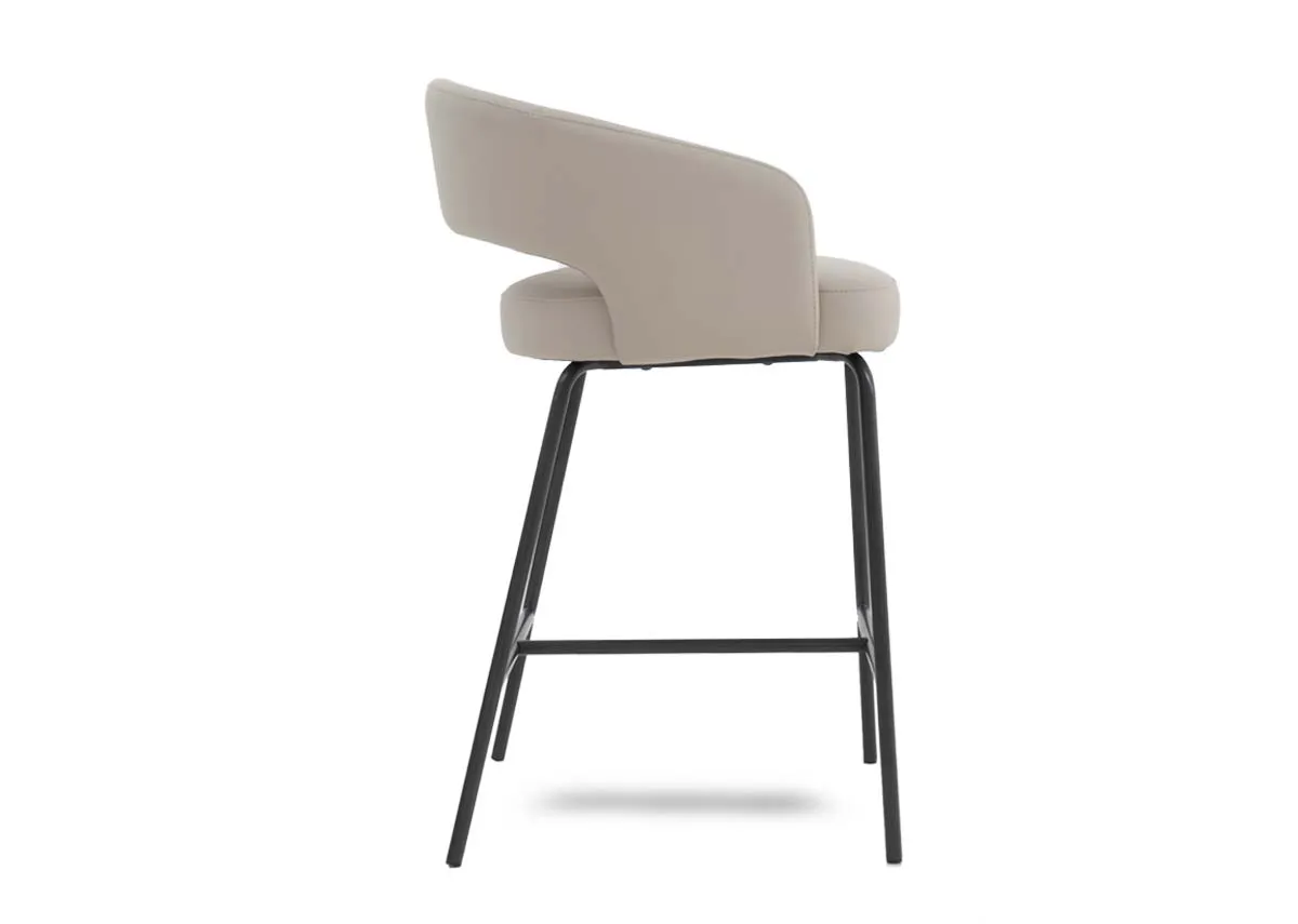 An ivory leather bar stool with black metal frame from EZ Livings Matteo range. Side view of low arched arm rests.