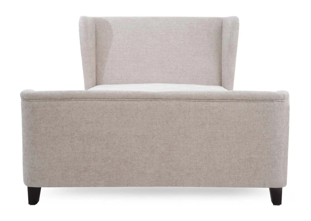 A beige fabric bed frame with a tall winged headboard and a low footboard viewed from the front.