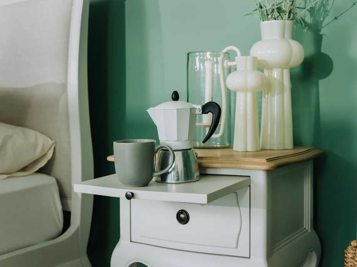 A lifestyle image of the Amelie locker with shelf pulled showing room for coffee pot and cup.