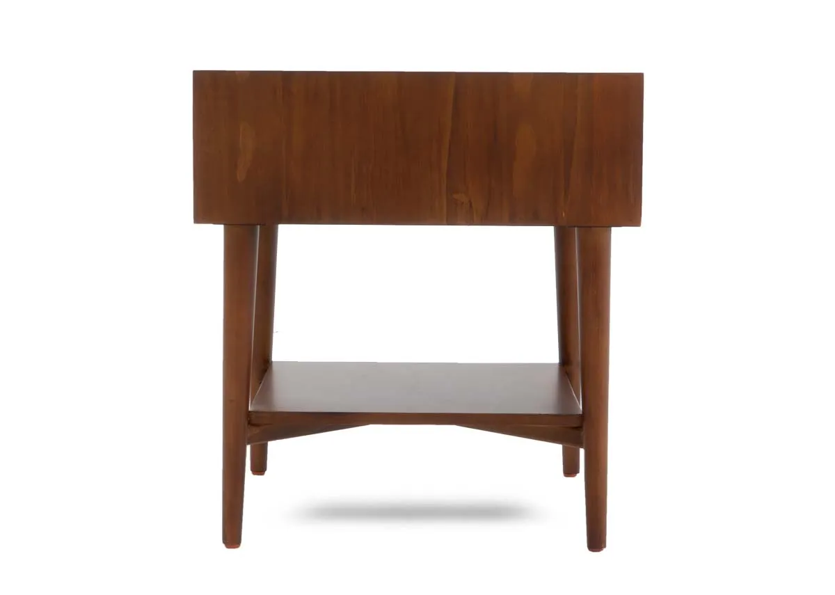 The back view of a dark pine lamp table showing the solid panel backing and tapered legs.