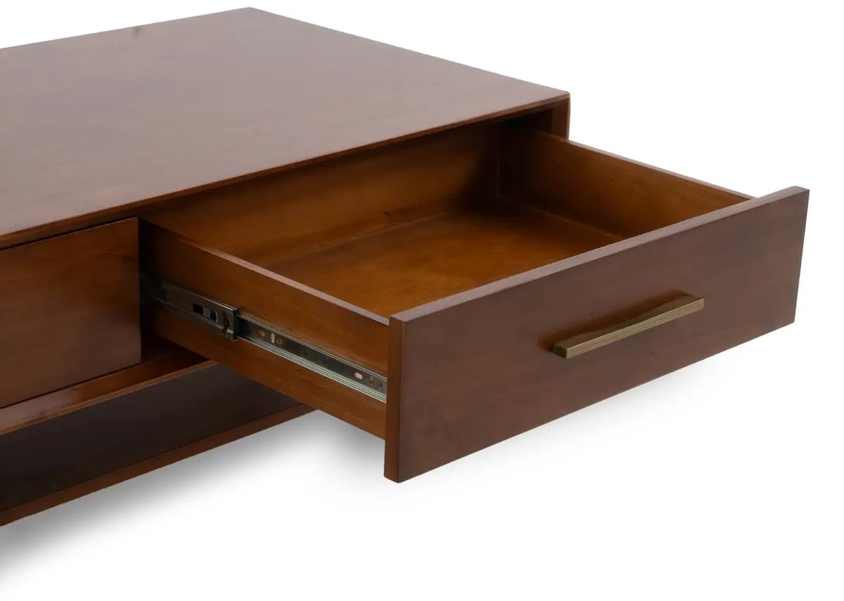 A close up view of an open drawer on the dark pine coffee table showcasing the interior and metal drawer slides.
