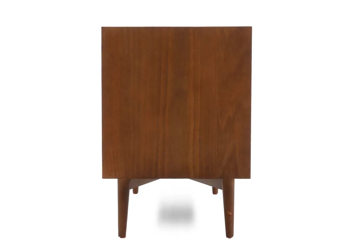 The back view of a wide dark pine display unit showing the solid panel backing of the bottom drawer section.