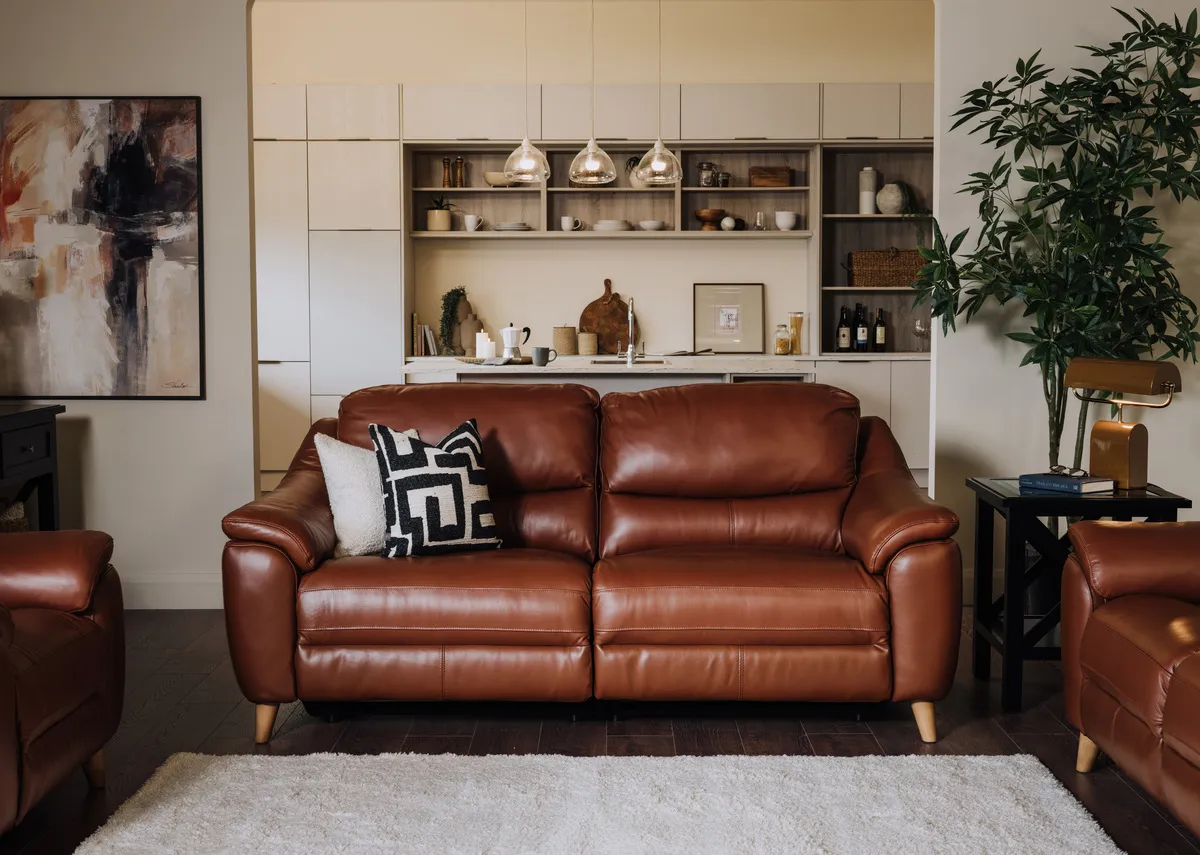 A lifestyle image of the Blaze 2 seater fixed sofa with Hampton black tables.